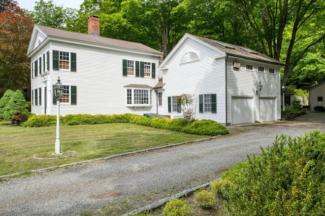 80 W Main St, Chester, CT 06412 - view of front of house with gravel driveway, a chimney, a front lawn, an attached garage, and roof with shingles