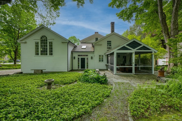 80 W Main St, Chester, CT 06412 - rear view of house with a sunroom, a patio area, and a chimney