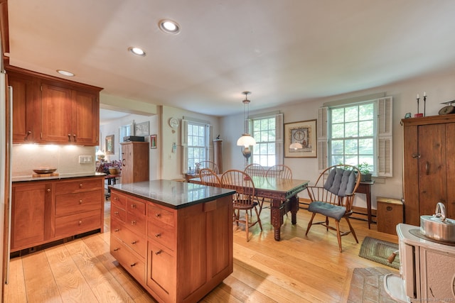 80 W Main St, Chester, CT 06412 - kitchen with dark countertops, recessed lighting, light wood-style floors, healthy amount of natural light, and brown cabinetry