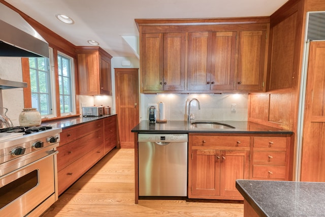 80 W Main St, Chester, CT 06412 - kitchen featuring stainless steel appliances, a sink, wall chimney range hood, recessed lighting, and light wood-style flooring