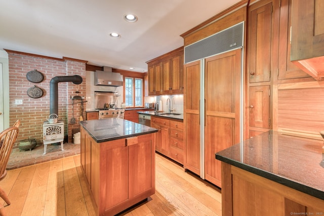 80 W Main St, Chester, CT 06412 - kitchen with a wood stove, high quality appliances, wall chimney range hood, light wood-style floors, and recessed lighting