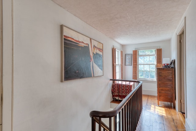 80 W Main St, Chester, CT 06412 - corridor with a textured ceiling, hardwood / wood-style floors, and an upstairs landing