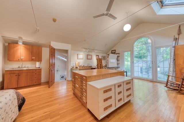 80 W Main St, Chester, CT 06412 - kitchen with a skylight, light wood-style floors, a sink, light countertops, and vaulted ceiling