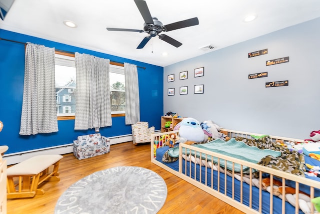 26 Davis Ave, Vernon, CT 06066 - bedroom with a baseboard radiator, wood finished floors, recessed lighting, and a ceiling fan