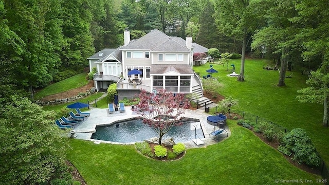 15 Arrowhead Way, Weston, CT 06883 - rear view of property with stairs, a sunroom, a patio, a chimney, and a wooded view