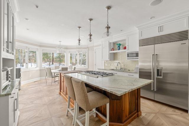 15 Arrowhead Way, Weston, CT 06883 - kitchen featuring built in appliances, baseboards, white cabinetry, a kitchen island, and open shelves