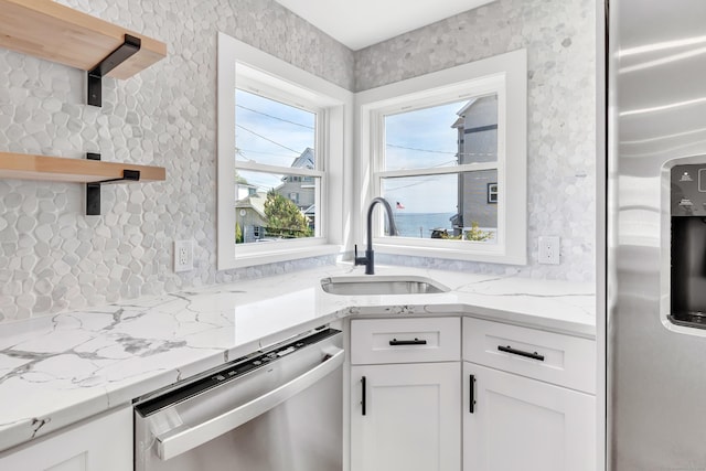 119 Melba St, Milford, CT 06460 - kitchen with stainless steel appliances, a sink, open shelves, white cabinets, and light stone countertops
