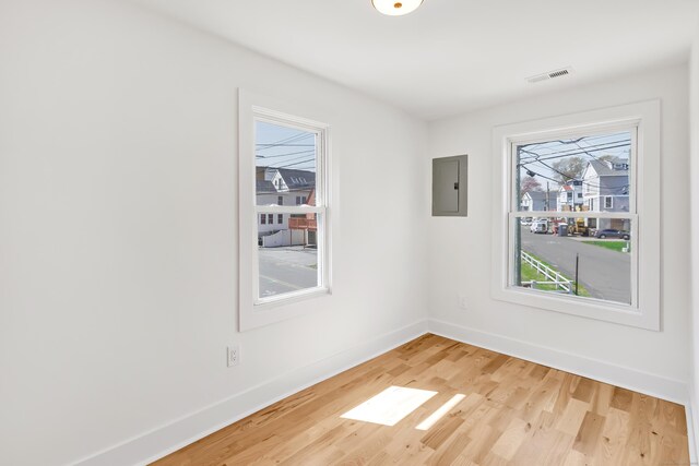 119 Melba St, Milford, CT 06460 - empty room with electric panel, baseboards, and light wood finished floors
