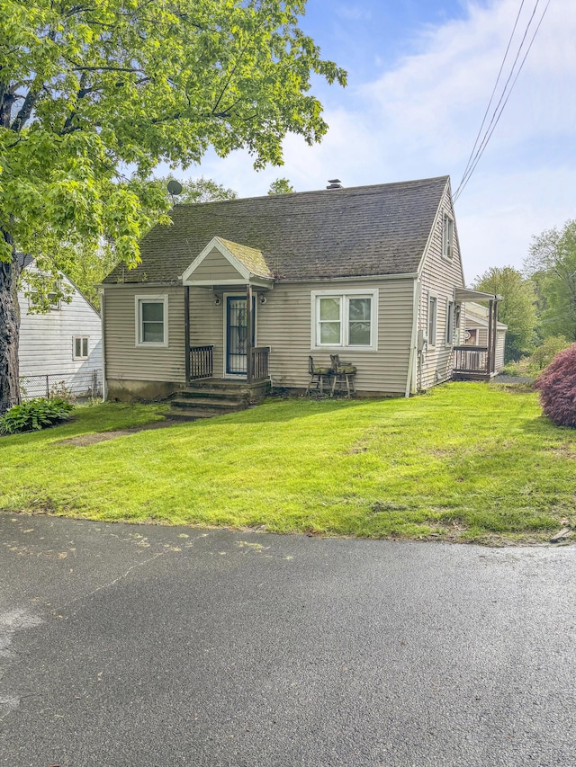 6 Peach St, Waterbury, CT 06708 - view of front facade featuring a front lawn and roof with shingles