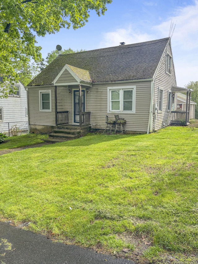 6 Peach St, Waterbury, CT 06708 - view of front of house featuring a shingled roof and a front lawn