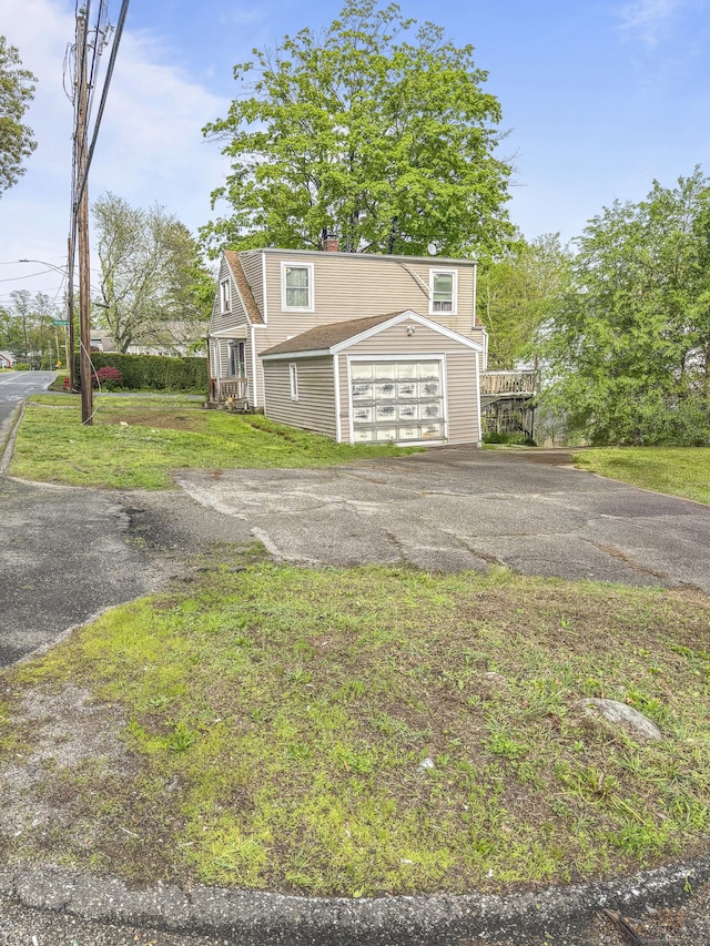 6 Peach St, Waterbury, CT 06708 - view of front of house featuring asphalt driveway, a front lawn, and a chimney