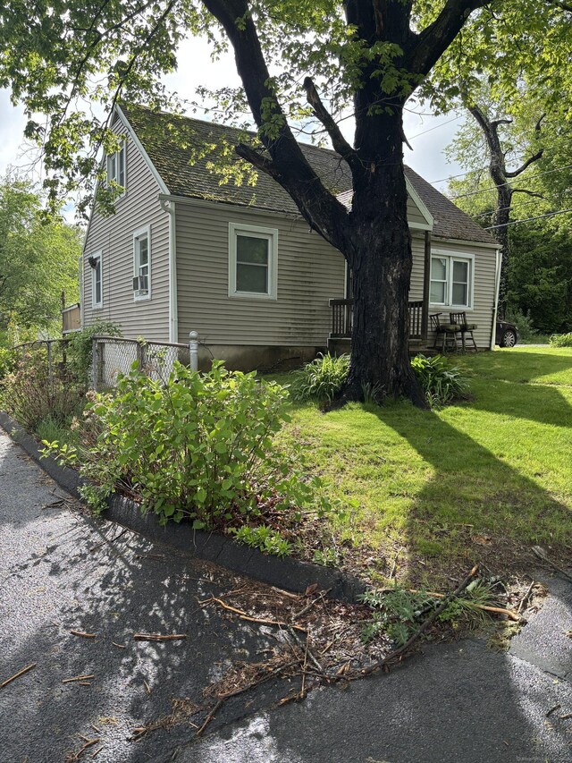 6 Peach St, Waterbury, CT 06708 - view of side of property featuring a lawn and roof with shingles