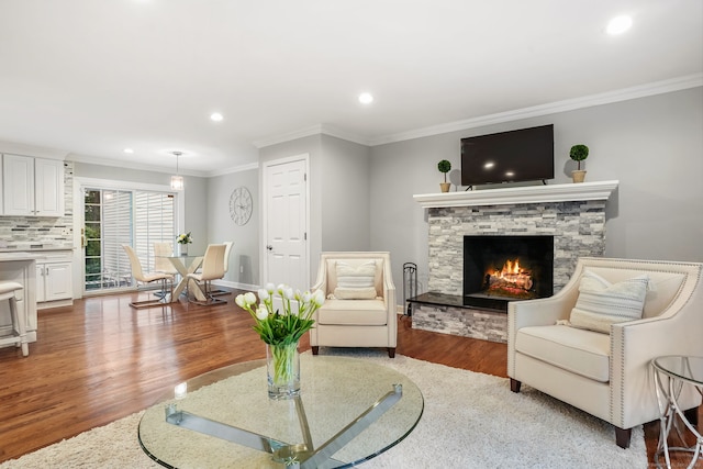 22 Fox Run, Wilton, CT 06897 - living area featuring wood finished floors, a stone fireplace, recessed lighting, ornamental molding, and baseboards
