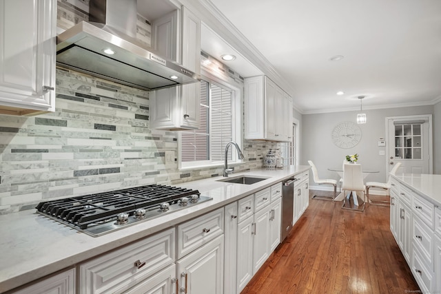 22 Fox Run, Wilton, CT 06897 - kitchen with a sink, appliances with stainless steel finishes, wall chimney exhaust hood, white cabinetry, and crown molding