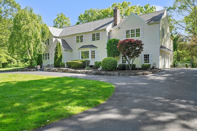 22 Fox Run, Wilton, CT 06897 - view of front of home with asphalt driveway, a chimney, a front lawn, a garage, and a shingled roof