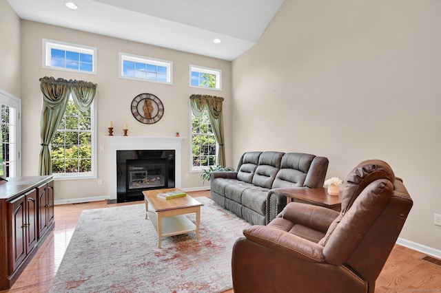 49 Bannan Ln Unit 49, Berlin, CT 06037 - living room with a high ceiling, light wood-style floors, baseboards, recessed lighting, and a fireplace