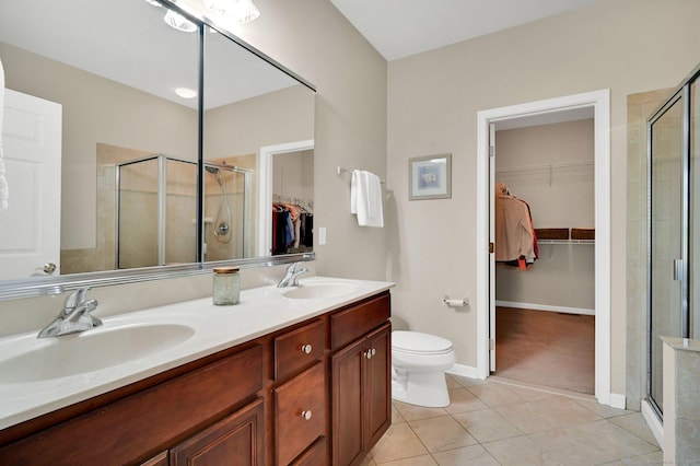 49 Bannan Ln Unit 49, Berlin, CT 06037 - bathroom with a spacious closet, double vanity, a stall shower, toilet, and tile patterned floors