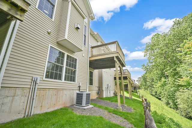 49 Bannan Ln Unit 49, Berlin, CT 06037 - rear view of property with central AC, a wooden deck, and a lawn