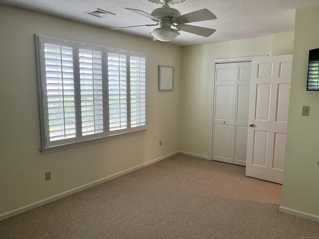 175 Berlin Ave Apt 36, Southington, CT 06489 - unfurnished bedroom featuring carpet, a textured ceiling, a closet, baseboards, and a ceiling fan