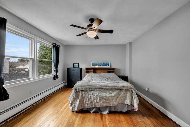 74 Belmont St, New Britain, CT 06053 - bedroom featuring a baseboard radiator, wood finished floors, baseboards, and ceiling fan