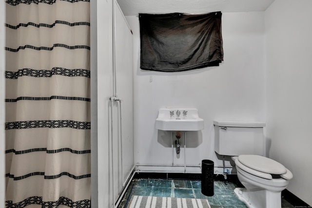 74 Belmont St, New Britain, CT 06053 - bathroom featuring toilet, curtained shower, and baseboards