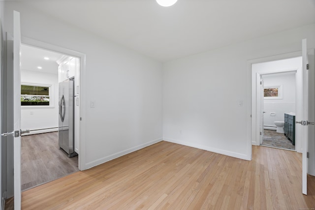 27 Hickory St, Plymouth, CT 06786 - empty room featuring baseboard heating, light wood finished floors, and baseboards