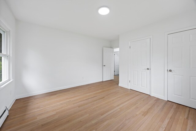 27 Hickory St, Plymouth, CT 06786 - unfurnished bedroom featuring light wood-type flooring, baseboard heating, and baseboards