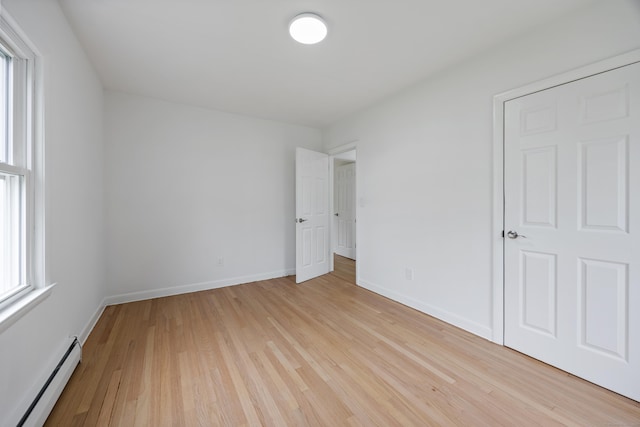 27 Hickory St, Plymouth, CT 06786 - unfurnished bedroom featuring a baseboard radiator, light wood finished floors, and baseboards