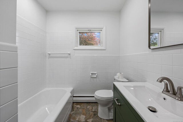27 Hickory St, Plymouth, CT 06786 - bathroom with baseboard heating, vanity, a bath, stone finish floors, and tile walls