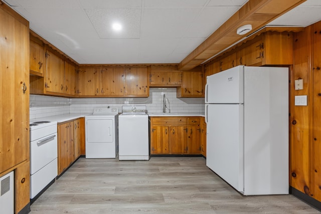 27 Hickory St, Plymouth, CT 06786 - kitchen featuring white appliances, a sink, washing machine and dryer, light countertops, and brown cabinetry