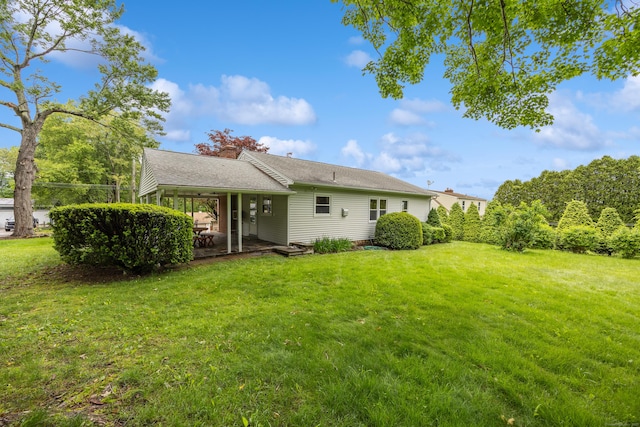 27 Hickory St, Plymouth, CT 06786 - rear view of property with a lawn and a patio area