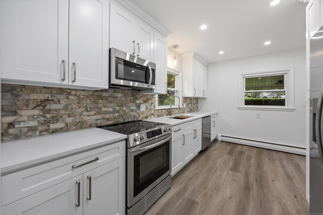 27 Hickory St, Plymouth, CT 06786 - kitchen with appliances with stainless steel finishes, a baseboard radiator, a sink, light wood finished floors, and healthy amount of natural light