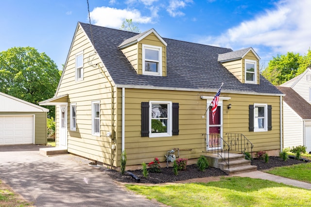 12 Pleasant Dr, Hamden, CT 06514 - cape cod house featuring an outbuilding, driveway, roof with shingles, and a garage