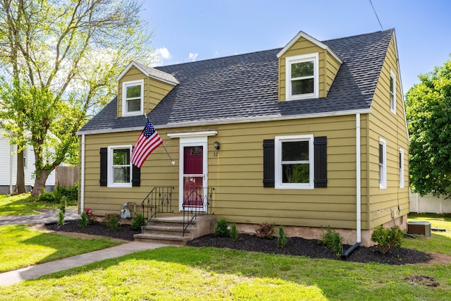 12 Pleasant Dr, Hamden, CT 06514 - cape cod home featuring a front yard, central air condition unit, and a shingled roof
