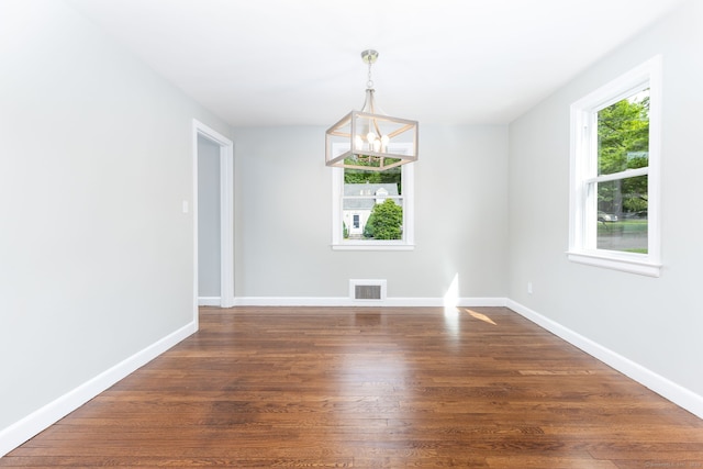 12 Pleasant Dr, Hamden, CT 06514 - unfurnished room featuring a chandelier, dark wood finished floors, and baseboards