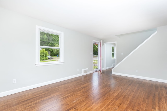 12 Pleasant Dr, Hamden, CT 06514 - spare room with healthy amount of natural light, stairway, wood finished floors, and baseboards