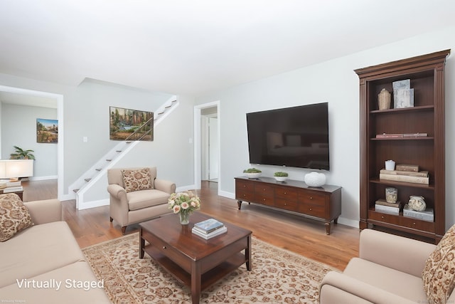 12 Pleasant Dr, Hamden, CT 06514 - living area with stairway, light wood finished floors, and baseboards