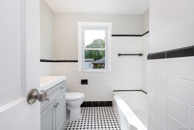 12 Pleasant Dr, Hamden, CT 06514 - full bath with tile walls, toilet, a tub, vanity, and tile patterned flooring