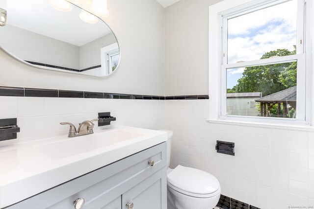 12 Pleasant Dr, Hamden, CT 06514 - half bath with tile walls, toilet, and vanity