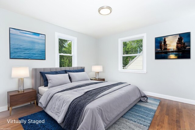 12 Pleasant Dr, Hamden, CT 06514 - bedroom featuring multiple windows, baseboards, and wood finished floors