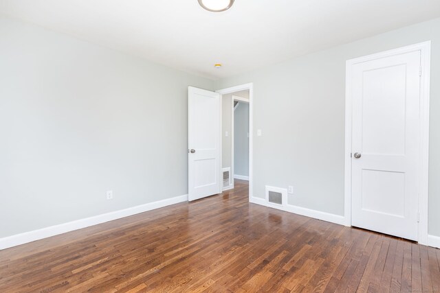 12 Pleasant Dr, Hamden, CT 06514 - empty room with dark wood finished floors and baseboards