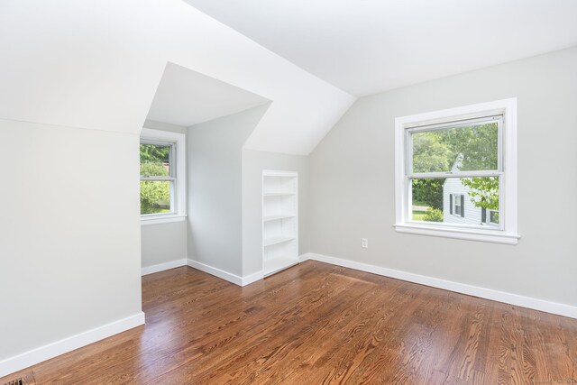 12 Pleasant Dr, Hamden, CT 06514 - additional living space featuring built in features, vaulted ceiling, wood finished floors, and baseboards