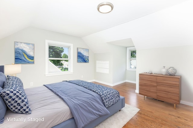 12 Pleasant Dr, Hamden, CT 06514 - bedroom featuring light wood finished floors, lofted ceiling, multiple windows, and baseboards