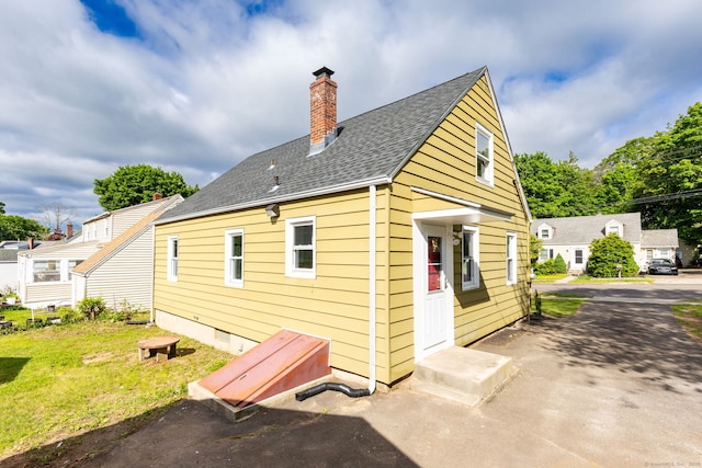 12 Pleasant Dr, Hamden, CT 06514 - back of property with a chimney and a shingled roof