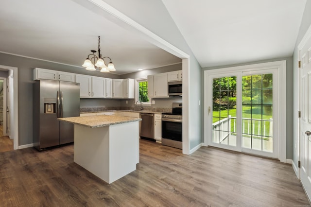 57 Quailcrest Rd, East Lyme, CT 06333 - kitchen featuring stainless steel appliances, a sink, a kitchen island, vaulted ceiling, and a chandelier