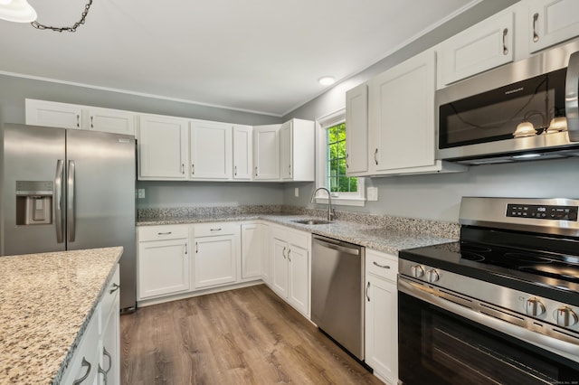 57 Quailcrest Rd, East Lyme, CT 06333 - kitchen with appliances with stainless steel finishes, a sink, white cabinets, wood finished floors, and recessed lighting