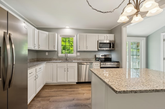 57 Quailcrest Rd, East Lyme, CT 06333 - kitchen featuring appliances with stainless steel finishes, a sink, dark wood-style flooring, white cabinets, and light stone countertops