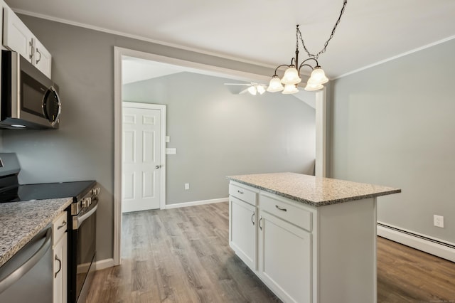57 Quailcrest Rd, East Lyme, CT 06333 - kitchen featuring stainless steel appliances, wood finished floors, white cabinetry, baseboard heating, and ornamental molding