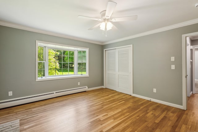 57 Quailcrest Rd, East Lyme, CT 06333 - unfurnished bedroom with a baseboard heating unit, a closet, crown molding, baseboards, and wood finished floors