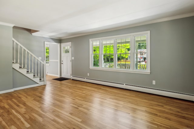 57 Quailcrest Rd, East Lyme, CT 06333 - foyer featuring a baseboard heating unit, ornamental molding, plenty of natural light, and wood finished floors